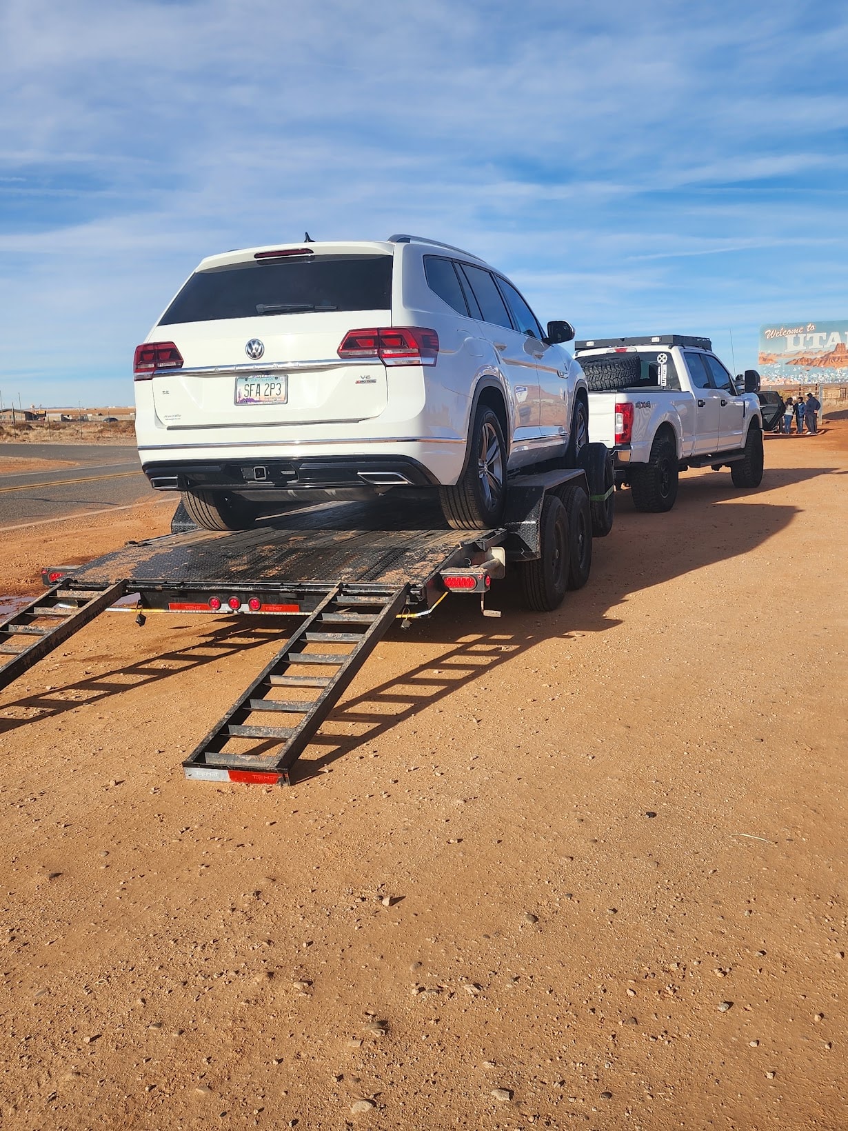 Adam R's VW Atlas loaded on Rez Auto's flatbed trailer near the Utah border